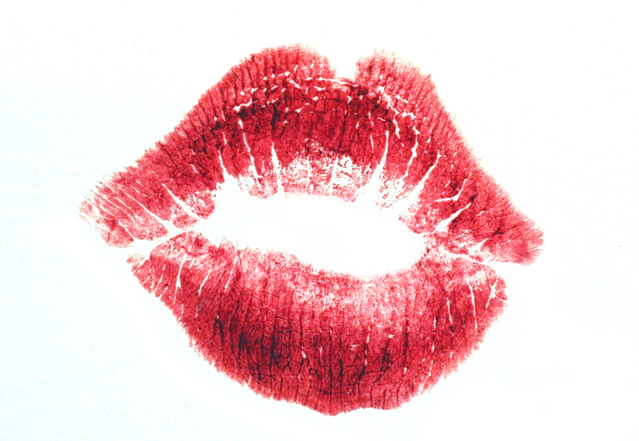 a welcoming kiss of red lips on a white background.